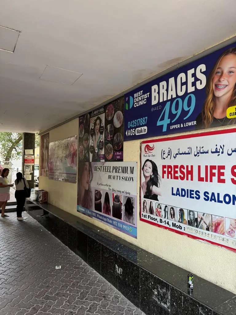 Covered walkway outside the Al Owais Building with Best Dentist posters